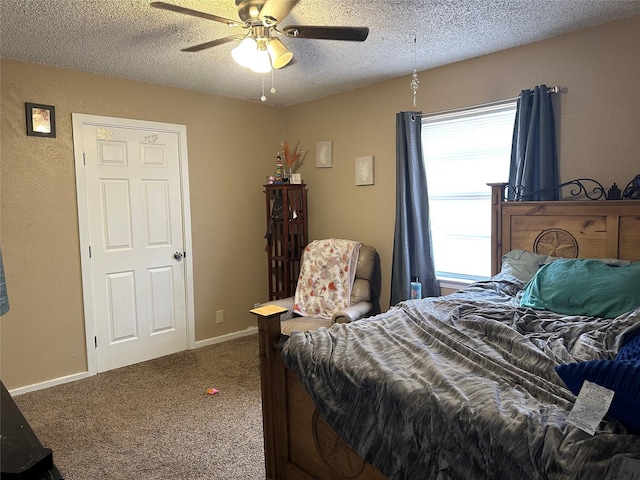 bedroom featuring ceiling fan, carpet, and a textured ceiling