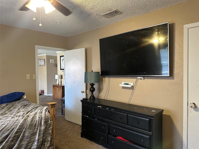 bedroom with a textured ceiling, carpet floors, and ceiling fan