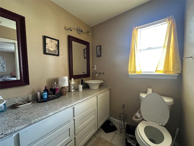 bathroom featuring vanity, tile patterned floors, and toilet