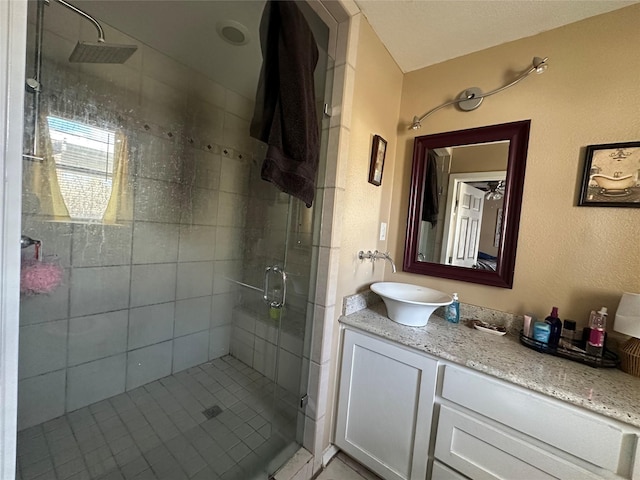 bathroom with an enclosed shower and vanity