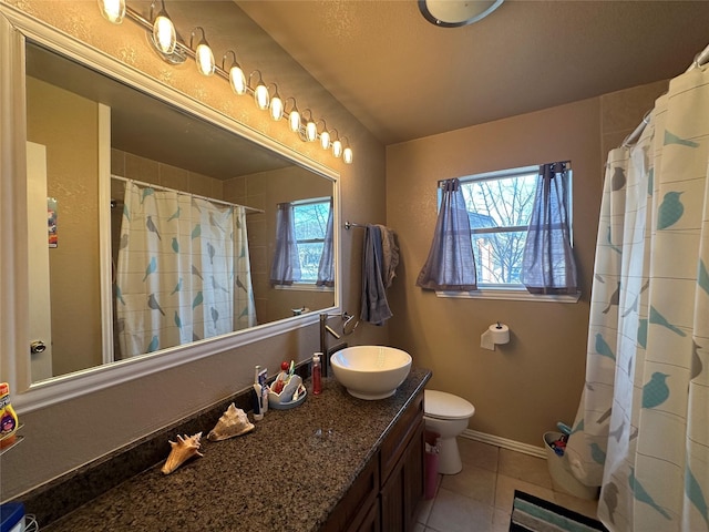 bathroom with vanity, tile patterned floors, and toilet