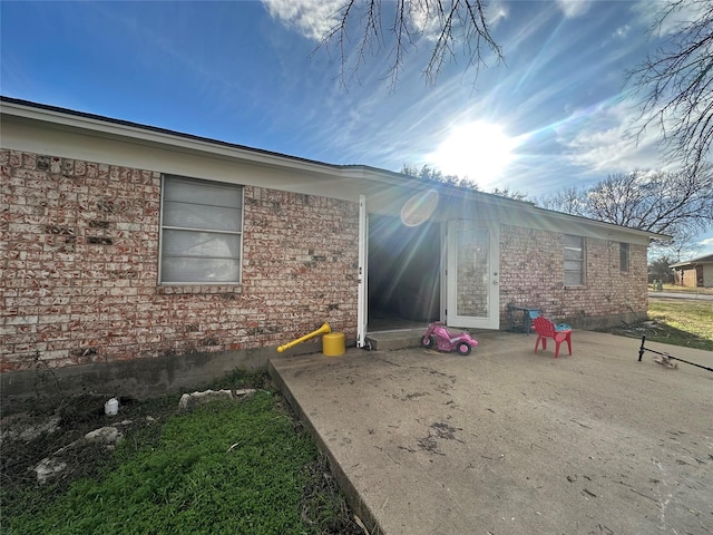 view of side of property featuring a patio