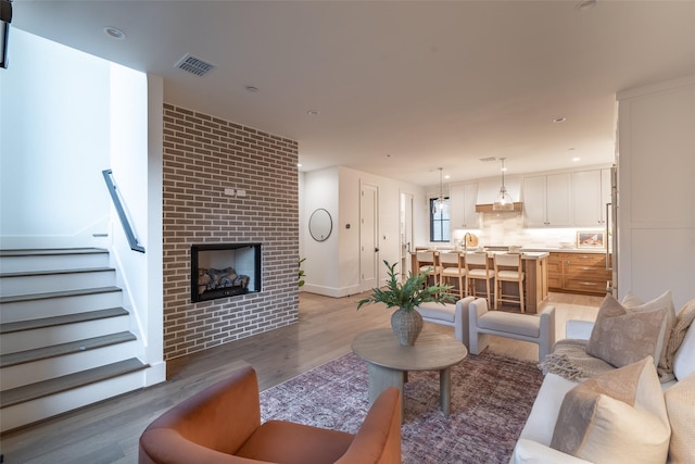 living room with hardwood / wood-style flooring and a fireplace