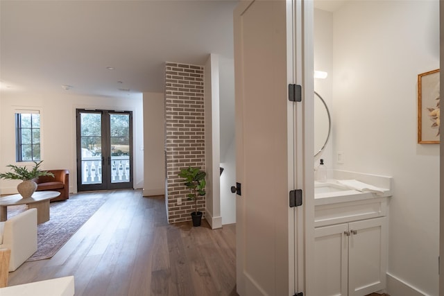 bathroom with french doors, vanity, and hardwood / wood-style floors