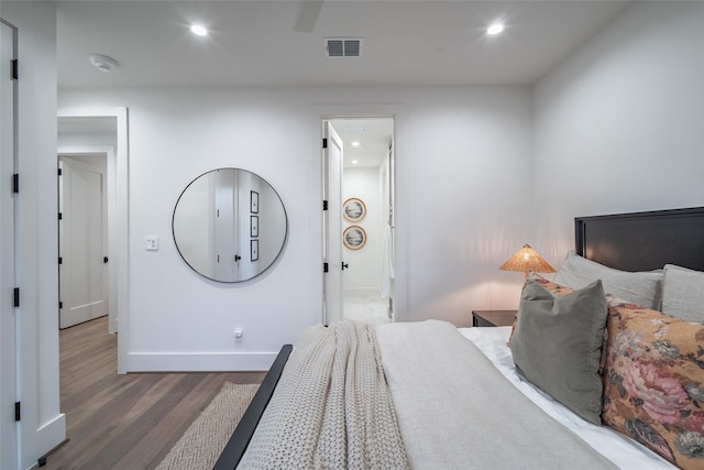 bedroom with dark hardwood / wood-style floors and ceiling fan