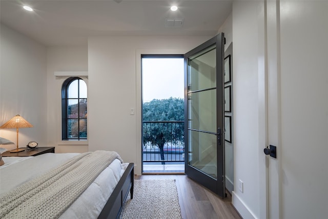 bedroom featuring access to exterior and light hardwood / wood-style floors