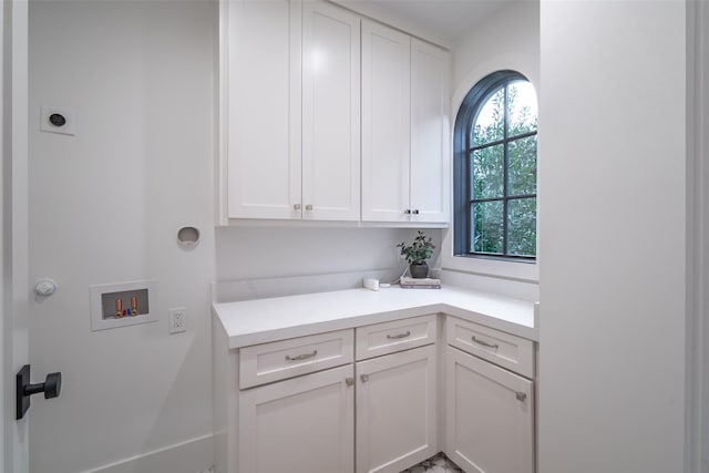 clothes washing area featuring cabinets, hookup for an electric dryer, and hookup for a washing machine