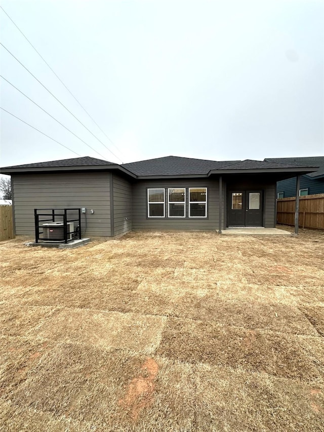 back of house with a lawn