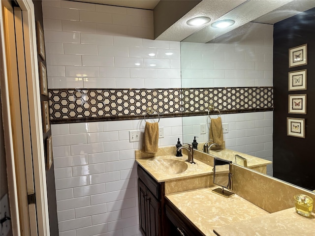 bathroom featuring vanity and tile walls