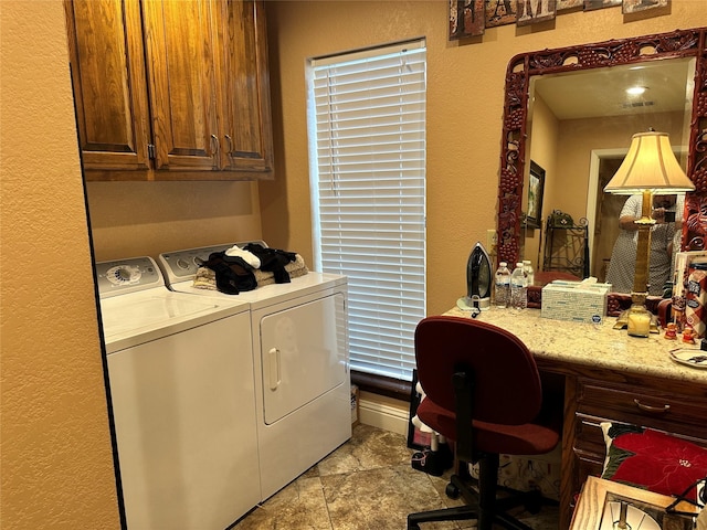 washroom featuring cabinets and separate washer and dryer