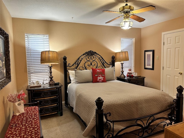 bedroom with ceiling fan and carpet