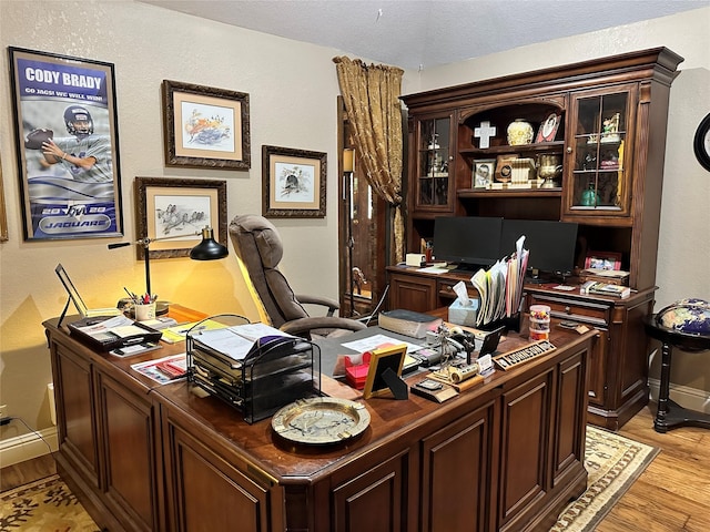 office with light wood-type flooring