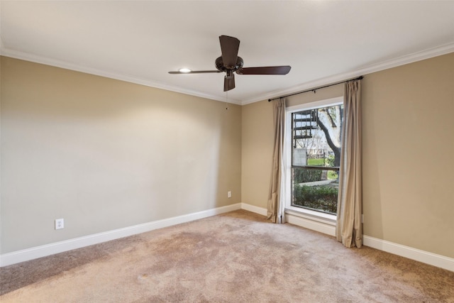 carpeted spare room with ornamental molding and ceiling fan