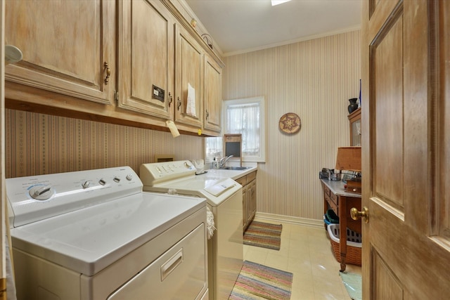 laundry area with cabinets, crown molding, sink, and independent washer and dryer