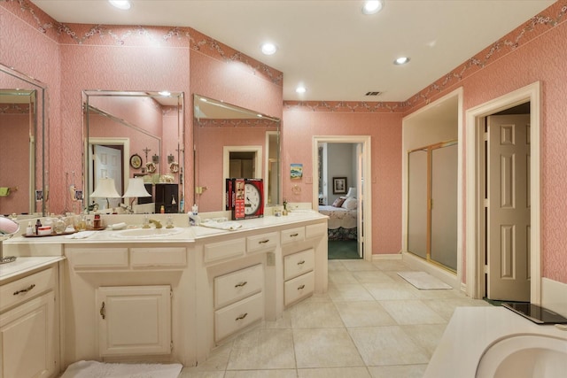 bathroom featuring vanity, tile patterned flooring, and a shower with door