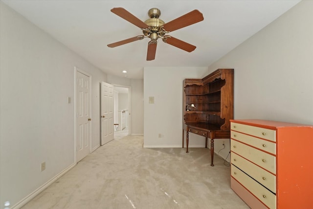 interior space with light carpet and ceiling fan