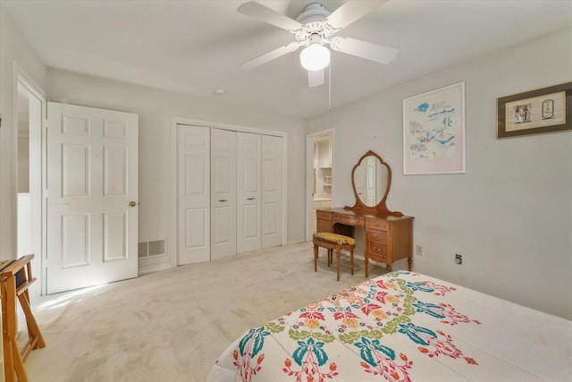 carpeted bedroom featuring ceiling fan and a closet