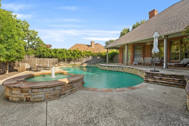 view of swimming pool featuring an in ground hot tub, pool water feature, and a patio area