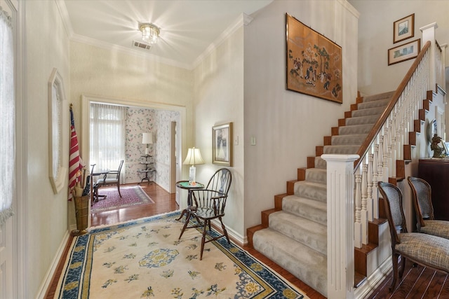 foyer featuring dark hardwood / wood-style flooring and crown molding