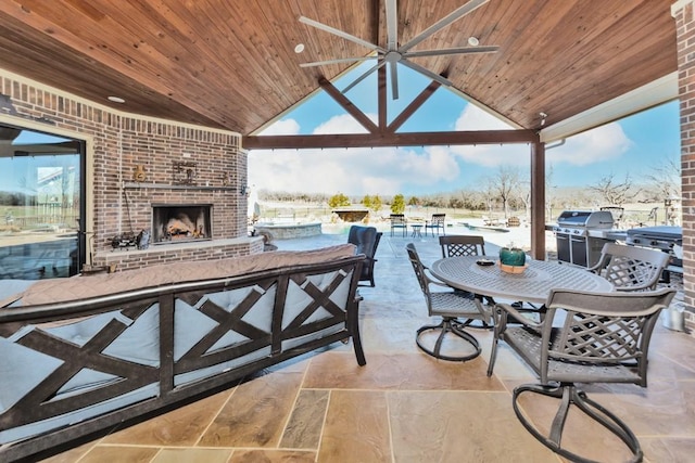 view of patio / terrace with an outdoor brick fireplace and a gazebo