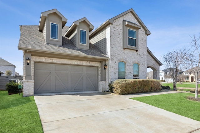 view of front of property featuring a garage and a front yard