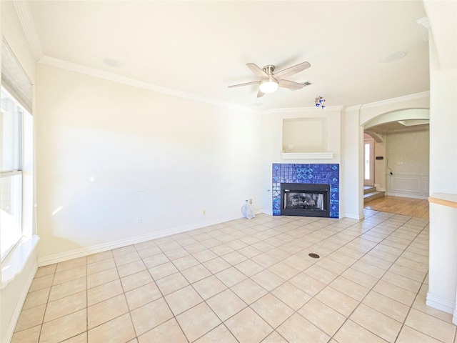 unfurnished living room featuring crown molding, plenty of natural light, and light tile patterned flooring