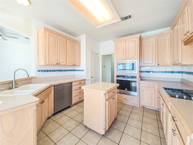 kitchen featuring light brown cabinetry, sink, and stainless steel appliances