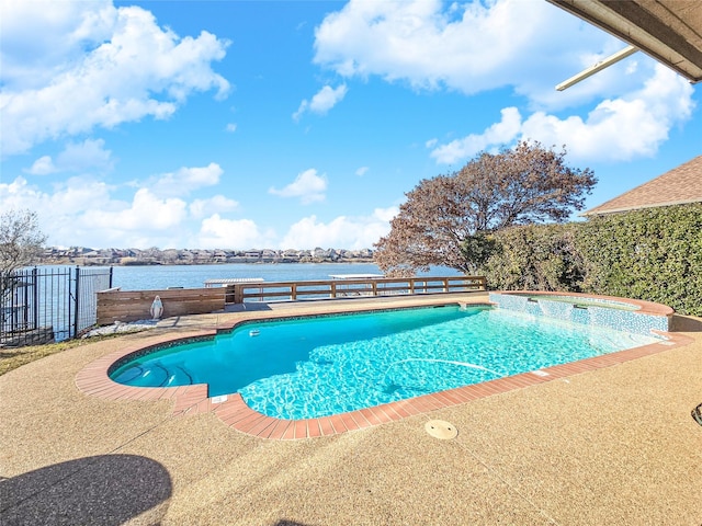 view of swimming pool with a patio and a water view