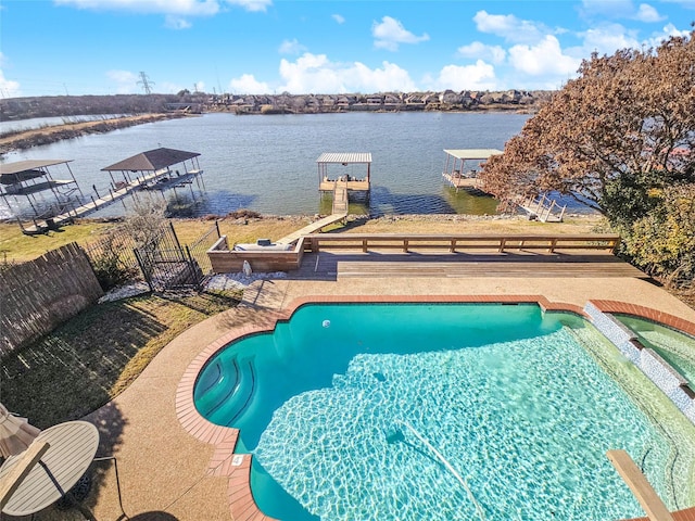 view of swimming pool featuring a water view and a dock