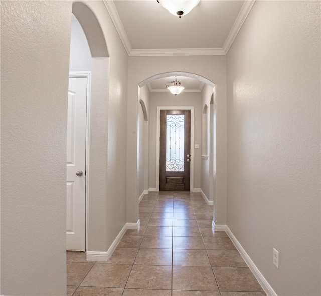 doorway featuring ornamental molding and light tile patterned floors