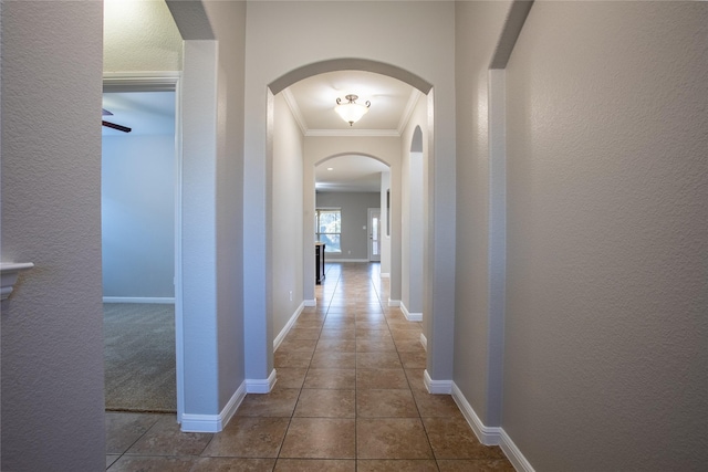 hallway with tile patterned flooring and ornamental molding