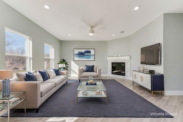 living room with ceiling fan and light hardwood / wood-style floors