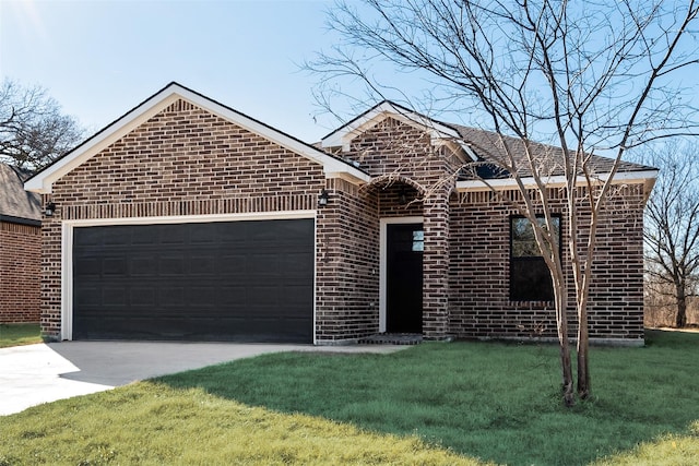 view of front of house featuring a garage and a front lawn