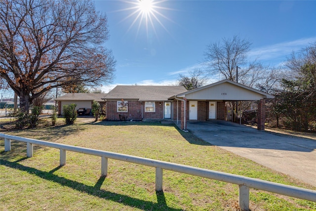 ranch-style house with a carport and a front yard