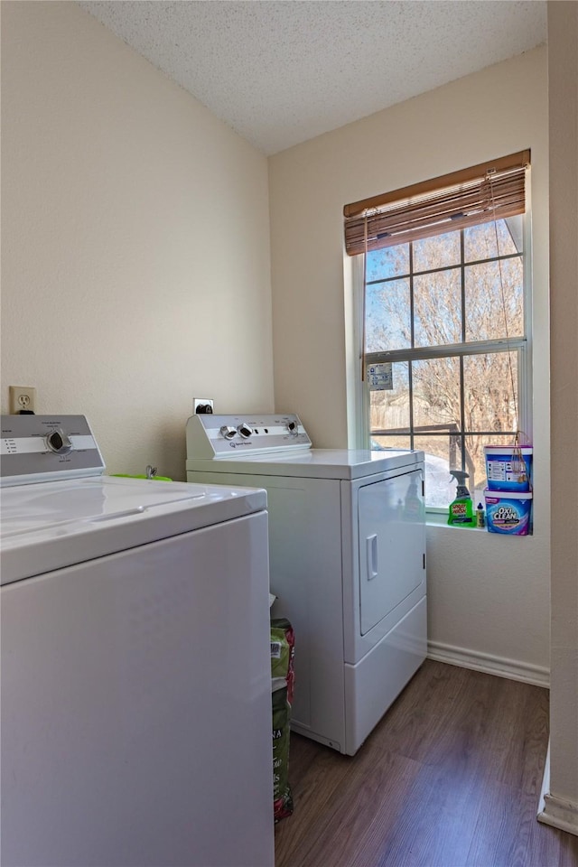 laundry area featuring washer and clothes dryer, dark hardwood / wood-style floors, and a textured ceiling