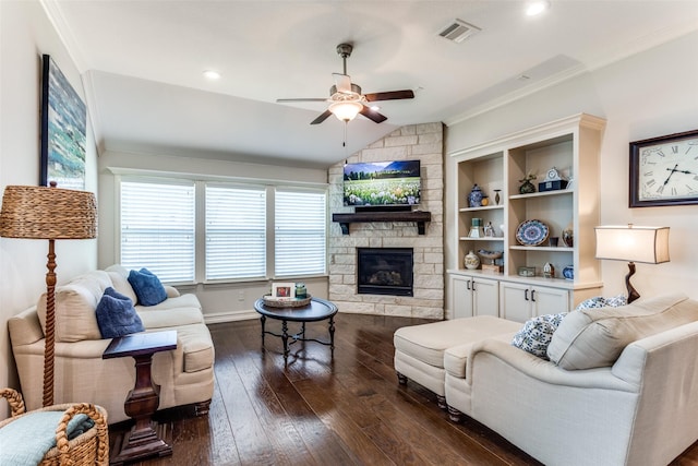 living room with crown molding, ceiling fan, dark hardwood / wood-style floors, a fireplace, and vaulted ceiling