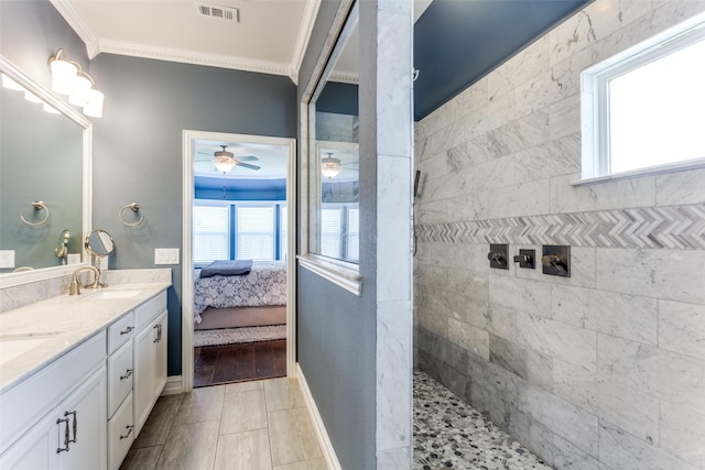 bathroom featuring crown molding, a tile shower, vanity, ceiling fan, and tile patterned flooring