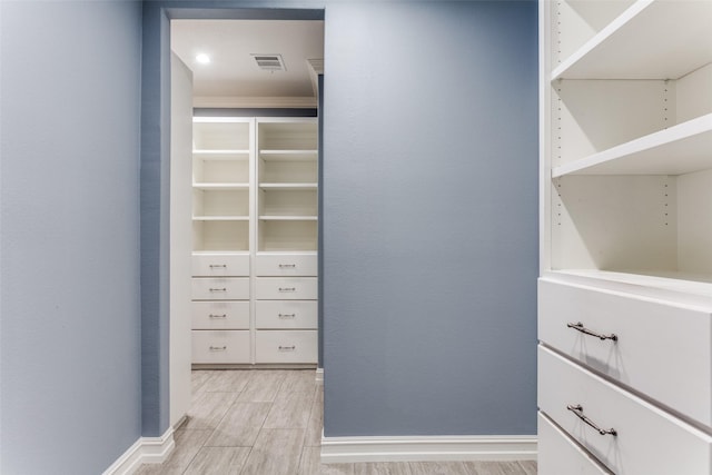 walk in closet featuring light hardwood / wood-style floors