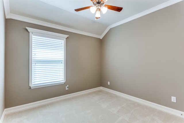 unfurnished room featuring crown molding, vaulted ceiling, light colored carpet, and ceiling fan