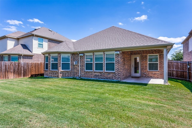 rear view of house featuring a patio and a yard