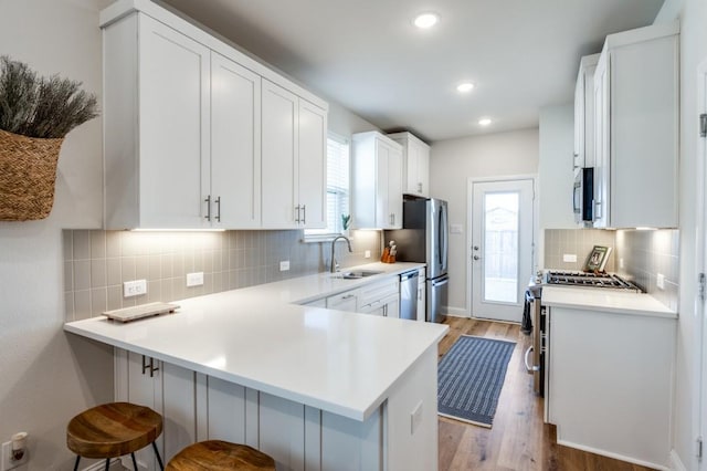 kitchen featuring white cabinetry and kitchen peninsula