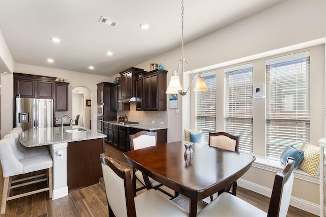 dining room with dark wood-type flooring and sink