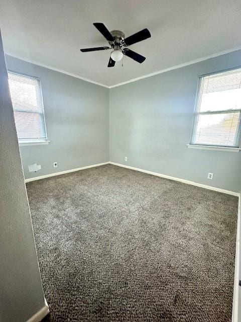 carpeted spare room featuring crown molding and ceiling fan