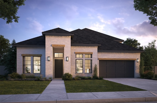 view of front facade with a garage and a lawn