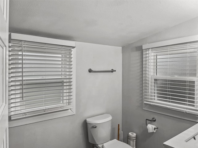 bathroom featuring toilet and a textured ceiling