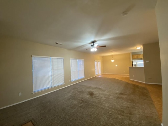 unfurnished room with ceiling fan and carpet flooring