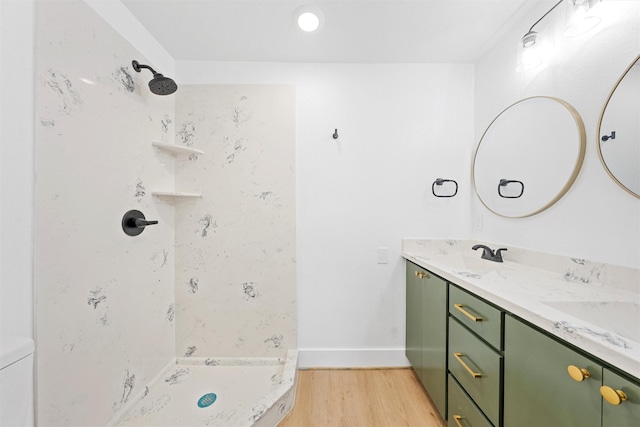 bathroom featuring vanity, wood-type flooring, and walk in shower