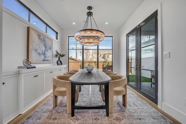 dining room featuring an inviting chandelier and light hardwood / wood-style flooring