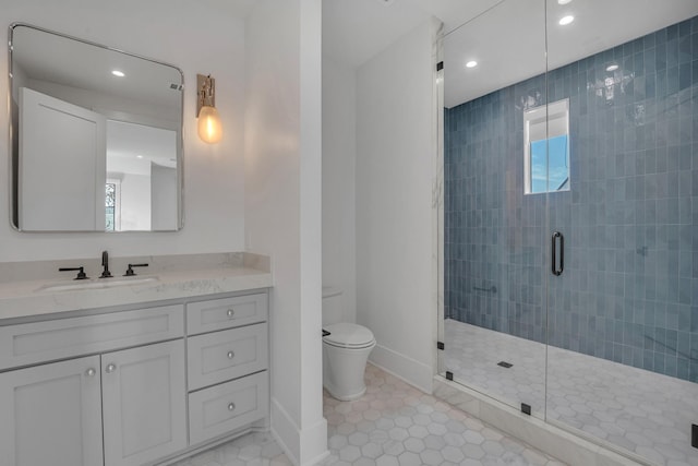 bathroom featuring vanity, tile patterned flooring, a shower with door, and toilet