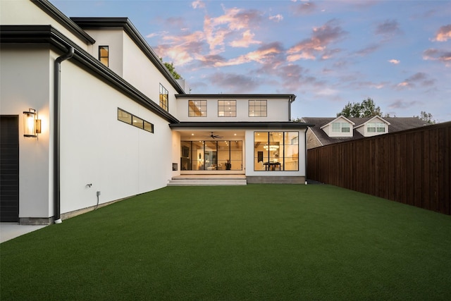 back house at dusk with a yard